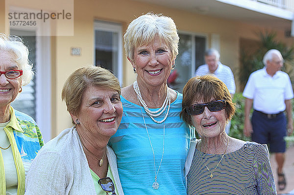 Drei ältere Frauen posieren für ein gemeinsames Foto
