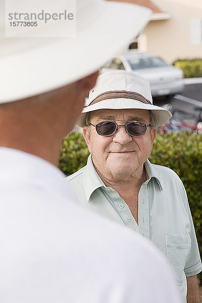 Älterer Mann im Gespräch mit einem anderen älteren Mann