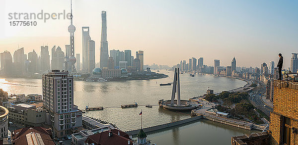Mann bewundert Blick über den Huangpu-Fluss und die Skyline von Shanghai am frühen Morgen  Shanghai  China