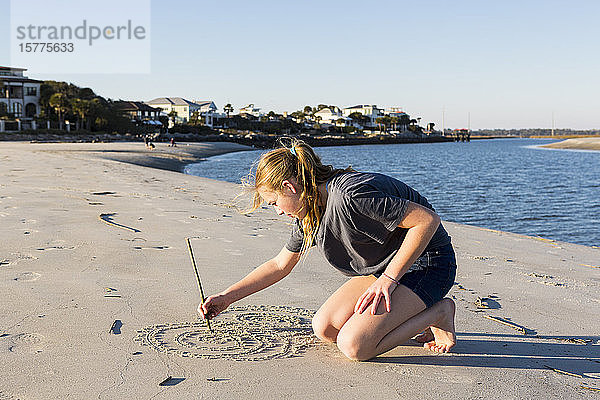 Ein junges Mädchen spielt in Sanddünen  am Strand