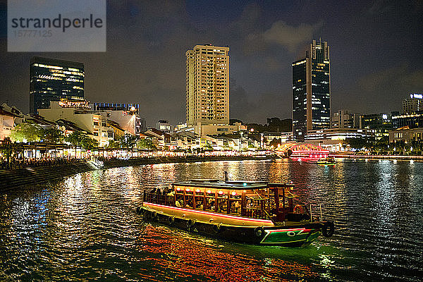 Touristenboot in der Nähe des historischen Boat Quay im Singapur-Fluss in der Abenddämmerung  Singapur  Südostasien  Asien