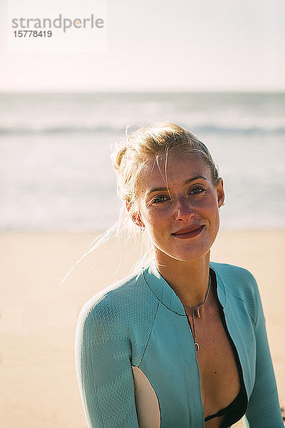 Porträt einer Frau im Neoprenanzug am Strand