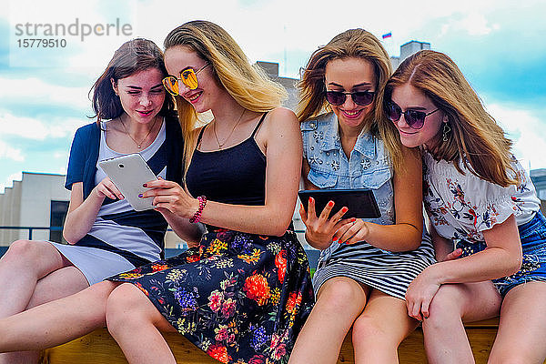 Freunde im Urlaub mit digitalem Tablet