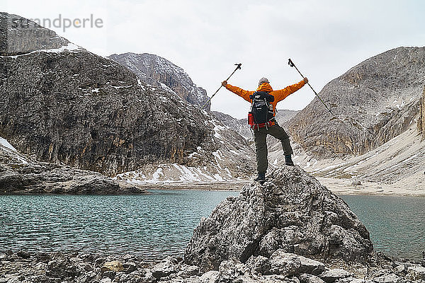 Wanderer bewundert Aussicht am See  Canazei  Trentino-Südtirol  Italien