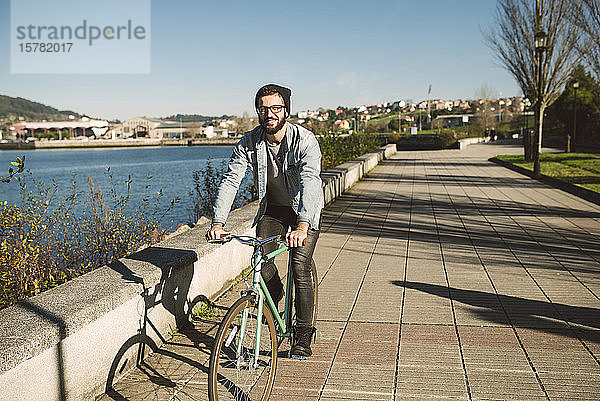 Junger Mann pendelt mit seinem Fixie-Rad in der Stadt