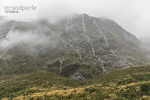 Neuseeland  Ozeanien  Südinsel  Südland  Fiordland-Nationalpark  Dauerregen mit Wasserfällen am Berghang