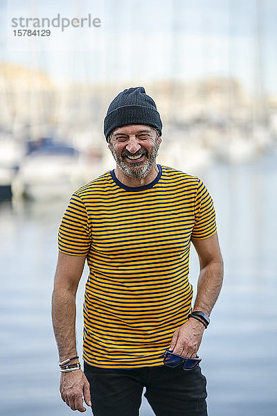 Porträt eines lachenden  reifen Mannes mit Mütze und gestreiftem T-Shirt  Alicante  Spanien