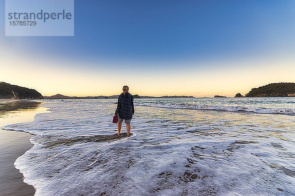 Frau am Strand von Hahei Beach bei Sonnenaufgang  Waikato  Nordinsel  Neuseeland