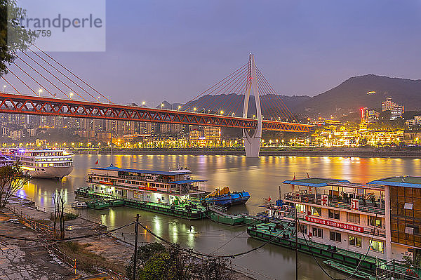Blick auf die Masangxi-Brücke und die Kreuzfahrtschiffe auf dem Jangtse-Fluss in der Abenddämmerung  Bezirk Yuzhong  Chongqing  China  Asien