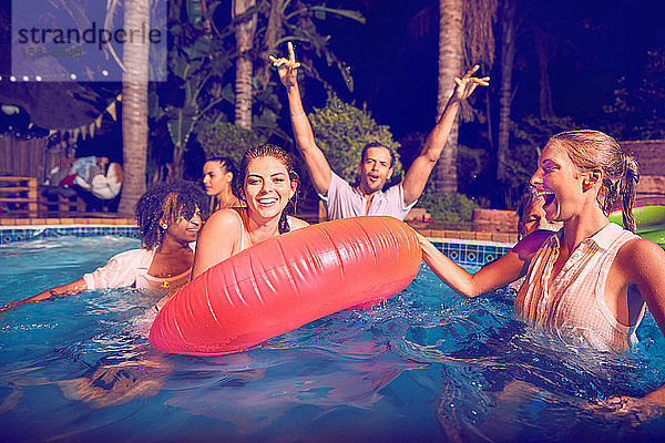 Porträt junge Freunde spielen im Schwimmbad bei Nacht