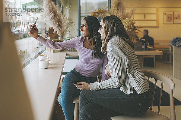 Zwei Frauen beim Selfie in einem Café