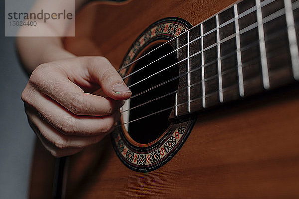 Frauenhand beim Gitarrespielen  Nahaufnahme