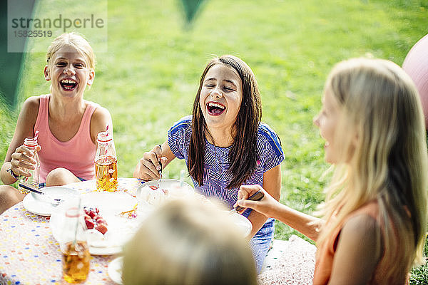 Glückliche Mädchen feiern Geburtstag im Freien