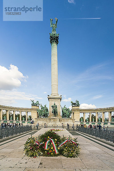 Das Millenniumsdenkmal mit blauem Himmel und Flugzeug am Himmel