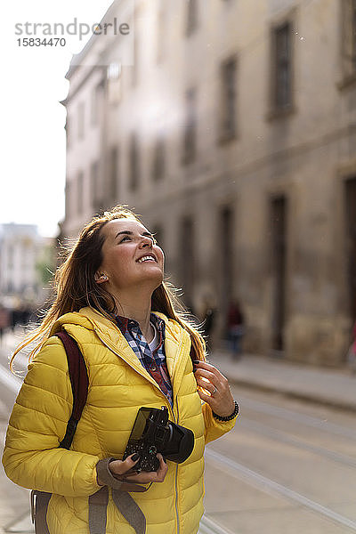 Junge Touristin mit einer Kamera beim Fotografieren in der europäischen Altstadt
