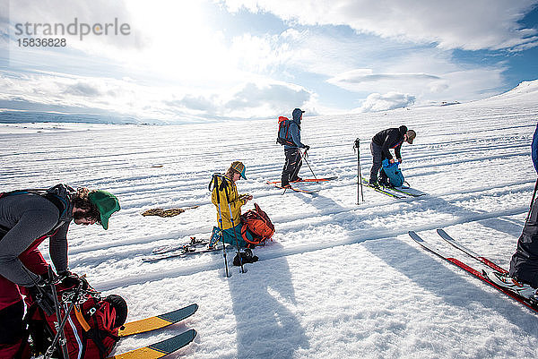 Gruppe von Skifahrern ruht sich auf einer Skitour durchs Hinterland aus