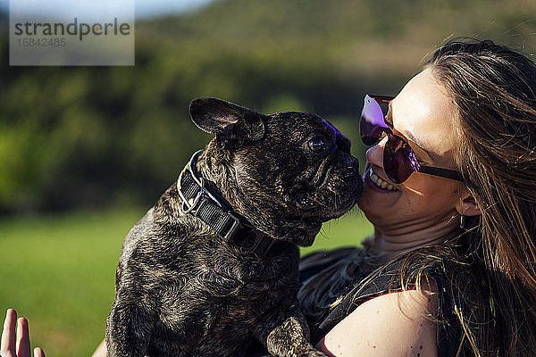 Schöne Frau mit ihrer französischen Bulldogge als Haustier