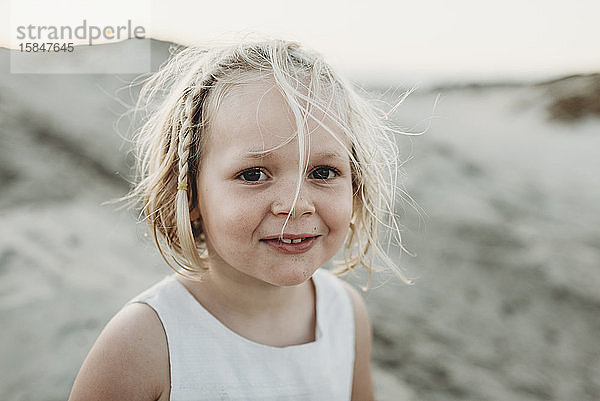 Porträt eines Mädchens im Vorschulalter  das am Strand lächelt