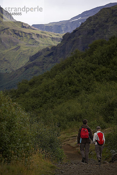 Paar  das auf dem Laugavegur-Pfad durch ein Tal wandert