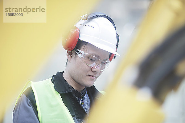 Bauingenieur mit Helm auf einer Straßenbaustelle