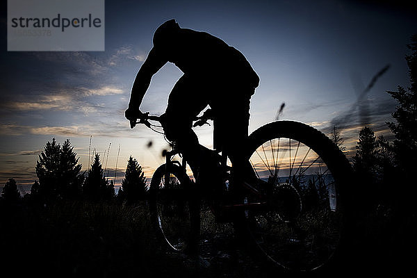 Ein Mountainbiker als Silhouette bei Sonnenuntergang in der Nähe von Missoula  Montana