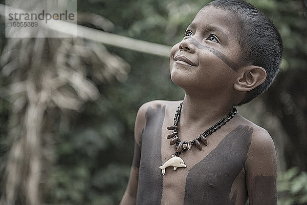 Ein niedlicher brasilianischer Indianer mit bemaltem Körper und Gesicht