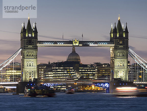 Tower Bridge und St. Paul's Cathedral mit der Themse im Vordergrund in der Abenddämmerung; London  England