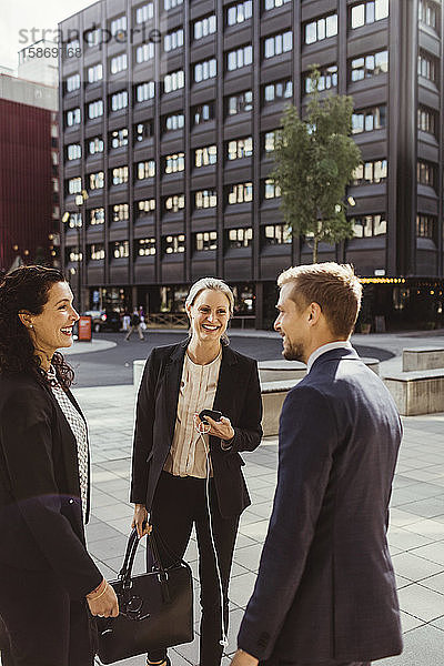 Lächelnde Unternehmer und Unternehmerinnen  die im Freien stehen