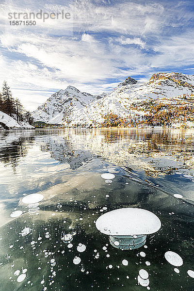 Methanblasen in der eisigen Oberfläche des Silsersees mit schneebedeckter Spitze  Silsersee  Engadin  Graubünden  Schweizer Alpen  Schweiz  Europa