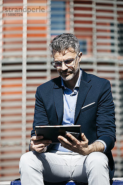 Geschäftsmann mit Tablette in der Stadt