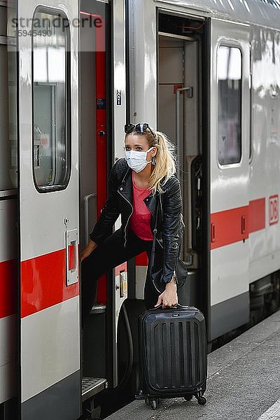 Frau mit Mundschutzmaske  beim Einstieg in Zug  Corona-Krise  Hauptbahnhof  Stuttgart  Baden-Württemberg  Deutschland  Europa