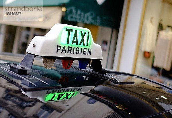 Schild eines Pariser Taxis spiegelt sich im Wagendach  Paris  Frankreich  Europa