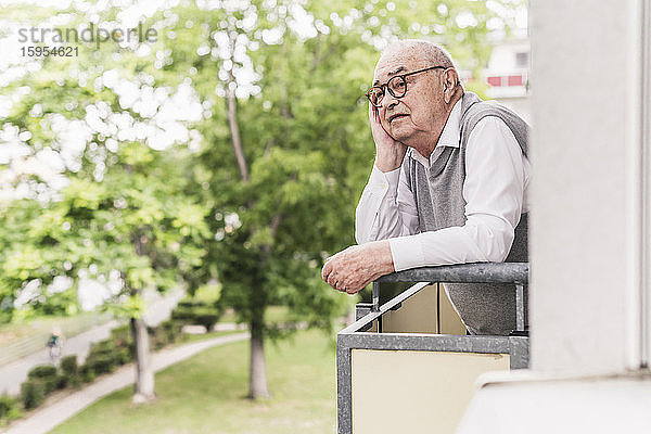 Porträt eines älteren Mannes  der auf einem Balkon steht und in die Ferne schaut