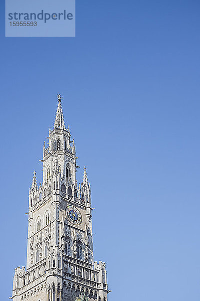 Deutschland  Bayern  München  Niedrigwinkelansicht des Uhrturms des Neuen Rathauses vor klarem blauen Himmel