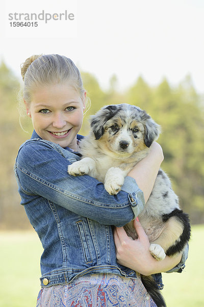 Junge Frau mit Australian Sheperd Welpen  Bayern  Deutschland  Europa