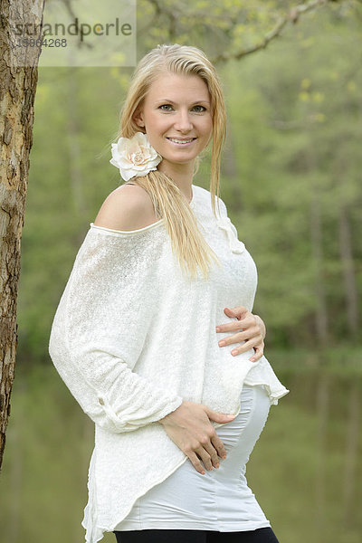 Junge schwangere Frau im Freien