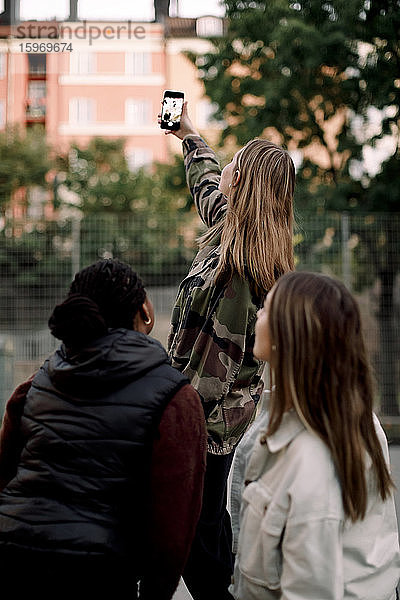 Teenagerin nimmt sich mit Freunden über Smartphone in die Stadt mit