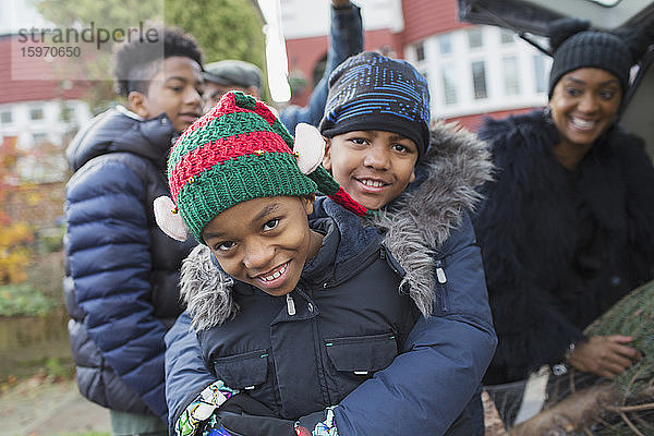 Porträt glückliche Brüder in Wintermänteln und Hüten  die sich umarmen