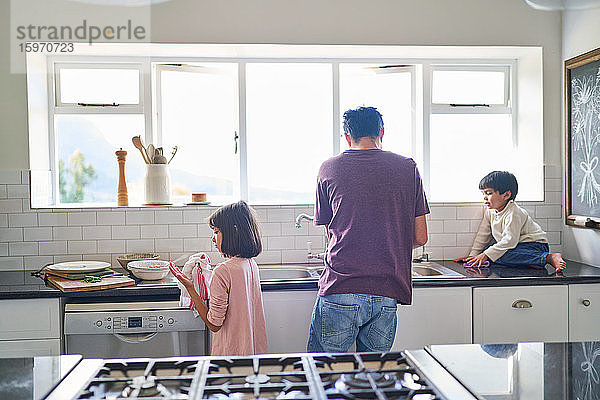 Familie beim Abwasch an der Spüle