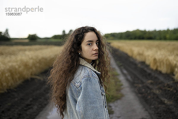 Russland  Omsk  Bildnis einer jungen Frau mit braunen Haaren im Feld stehend