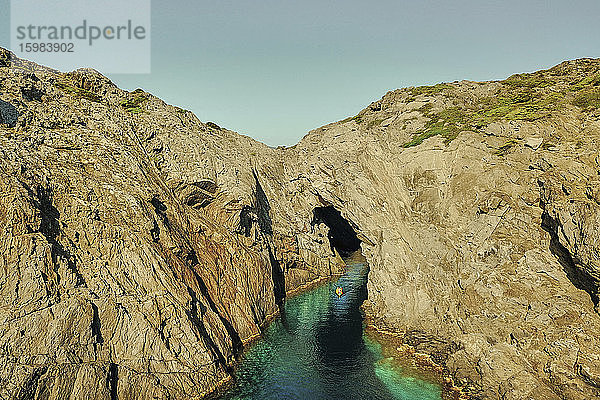 Spanien  Katalonien  Costa Brava  Mann im Kajak beim Betreten einer Höhle aus hoher Perspektive