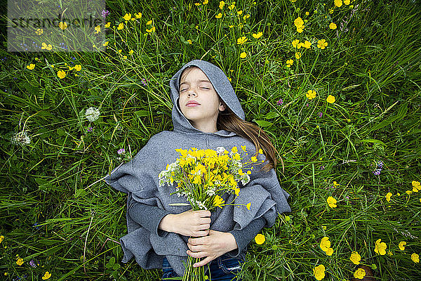 Mädchen pflückt gelbe Wildblumen