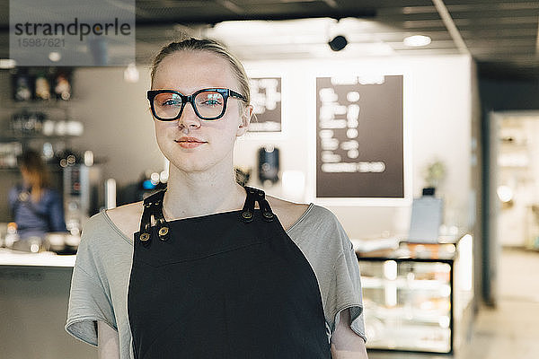 Porträt eines selbstbewussten transsexuellen Besitzers im Café