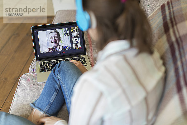 Teenagerin mit Laptop Video-Chat mit Freunden auf dem Sofa
