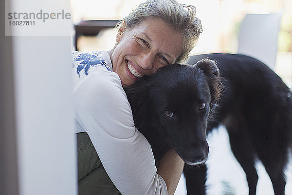 Porträt glückliche Frau umarmt Hund