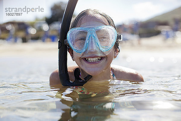Glückliches Mädchen mit Schnorchel und Taucherbrille im Meer