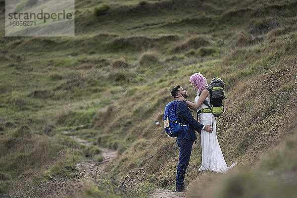 Brautpaar mit Kletterrucksäcken auf Wanderweg  Berg Urkiola  Spanien