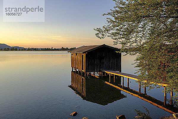 Deutschland  Bayern  Oberbayern  Loisachtal  Kochel am See  Bootshaus am Kochelsee bei Sonnenuntergang