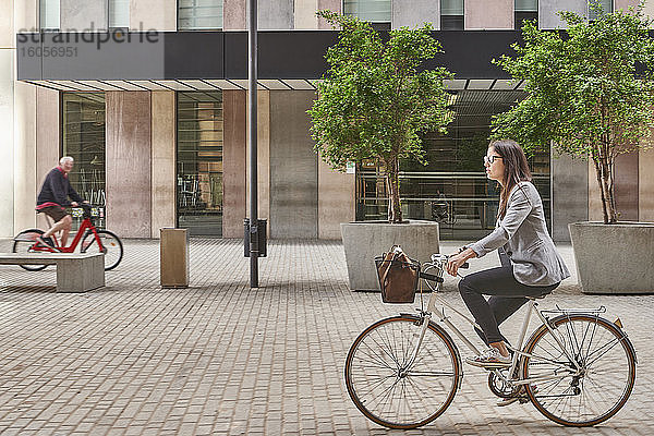 Geschäftsfrau beim Pendeln mit dem Fahrrad in der Stadt