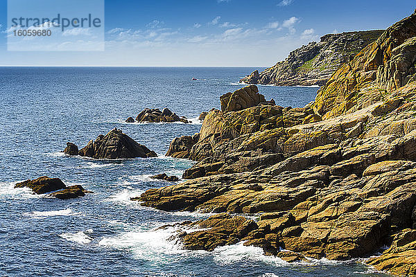 Felsige Felsformationen entlang der Küste mit blauem Himmel und Wolken; Grafschaft Cornwall  England